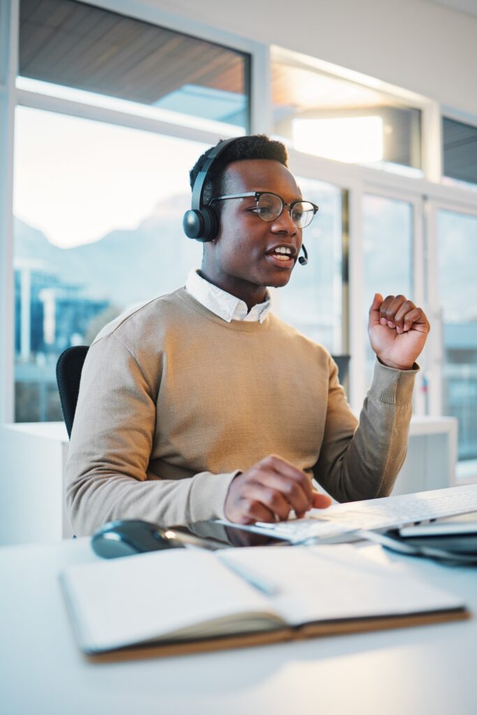 Call center, black man and consulting at computer for telemarketing, customer service and IT suppor